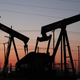 The sun sets beyond pumpjacks in the Belridge oil field near McKittrick, California.